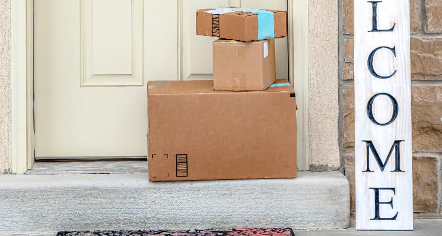 Boxes by the door of a residence with a welcome sign in Shreveport